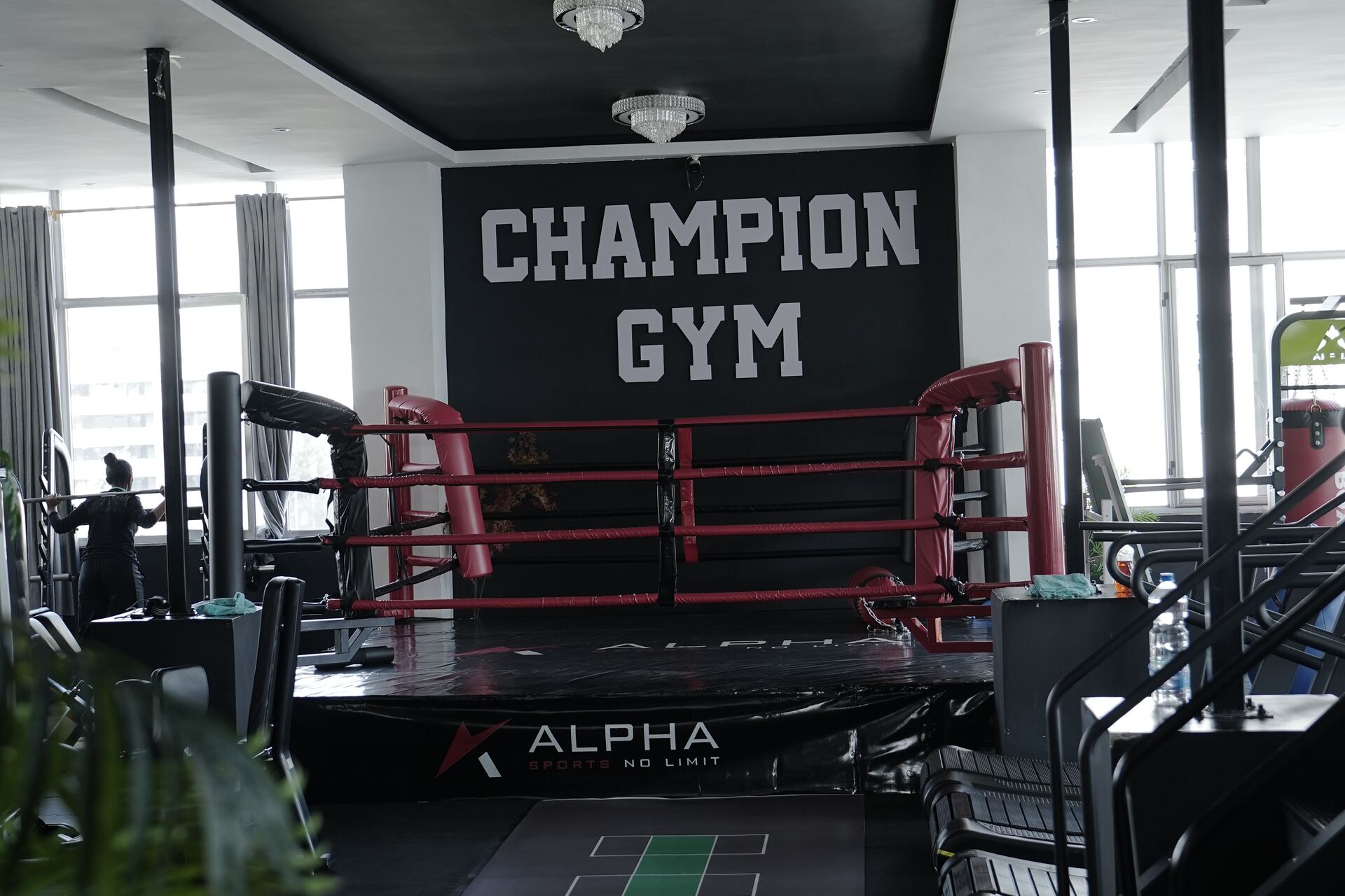 Champion Gym trainer and member fist-bumping at the front desk