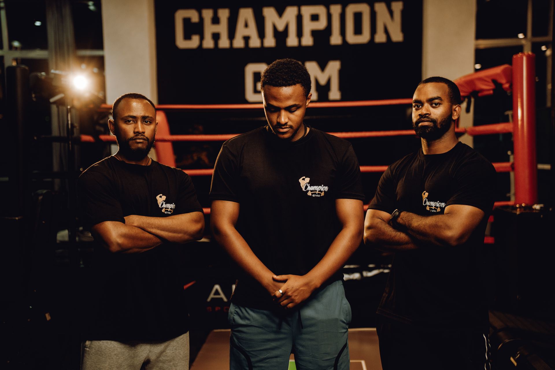 Champion Gym trainers standing together in front of the boxing ring